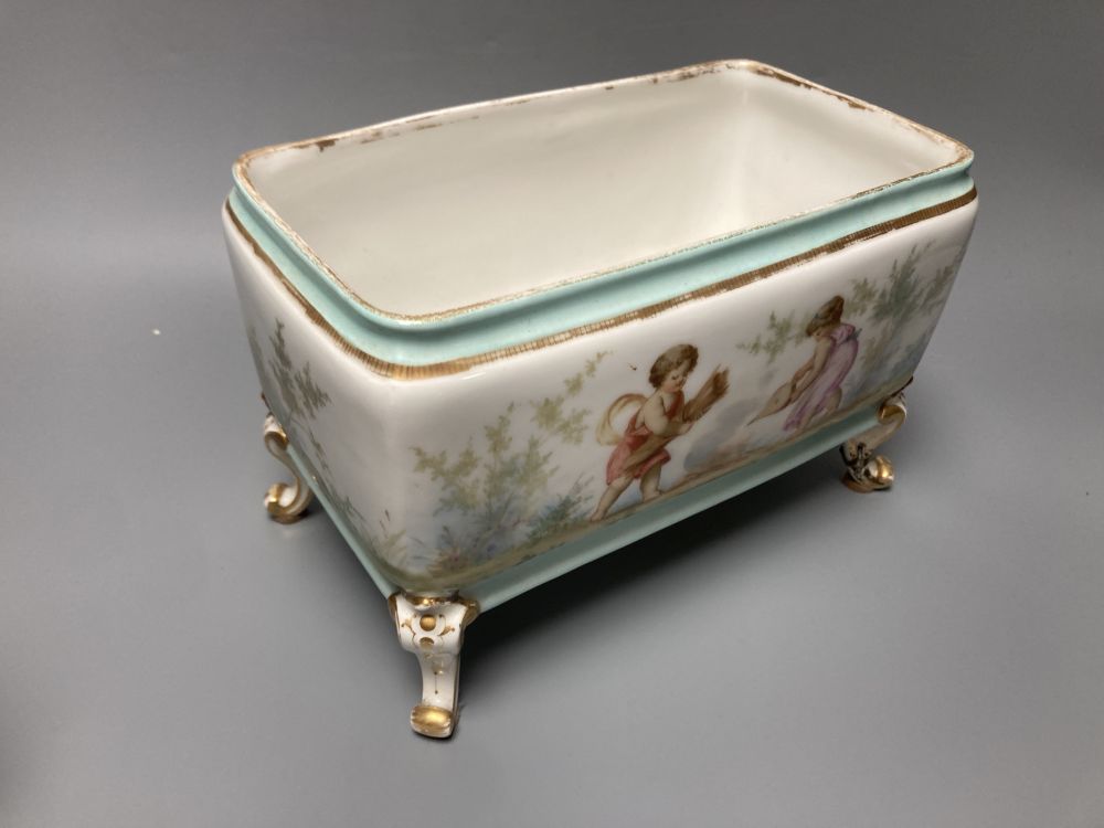 A set of three 19th century French porcelain jardinieres, painted with classical children playing, tallest 14.5cm width 22cm